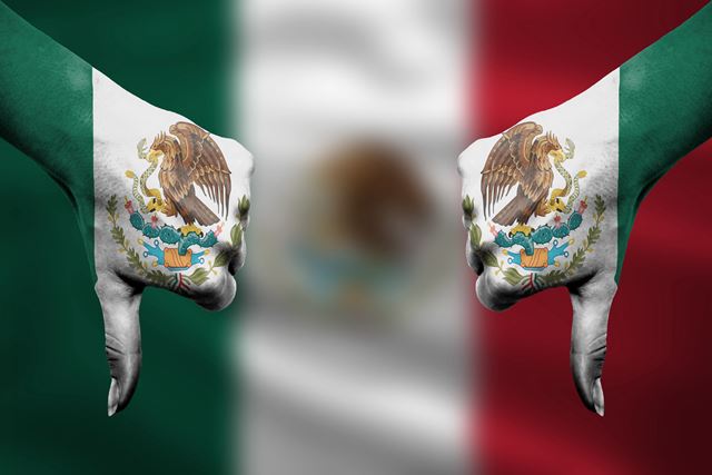 failure of Mexico - hands gesturing thumbs down in front of flag