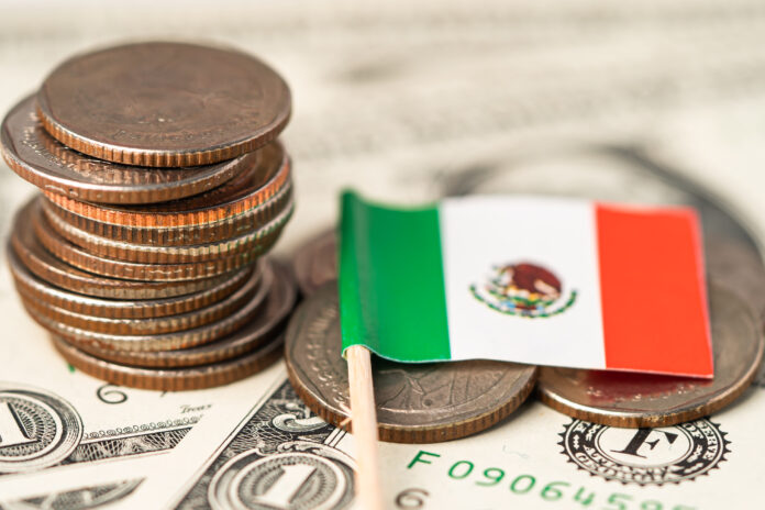 Mexico Flag on coins background, Business and finance concept. El pronóstico dado a conocer por BMI solo se asemeja con el de Banamex, que también apunta a un magro crecimiento de la economía de México de 0.2% este año.