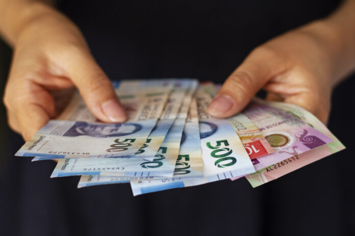 high-angle-hands-holding-mexican-banknotes
