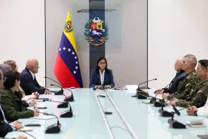 En respuesta a la intervención militar, la vicepresidenta de Venezuela, Delcy Rodríguez, encabezó una reunión de urgencia del Consejo de Defensa de la Nación en el Palacio de Miraflores, acompañada por altos funcionarios del Gobierno Bolivariano. Durante el encuentro, advirtió que el Ejecutivo venezolano ya había alertado sobre una agresión en curso bajo “falsas excusas y pretextos”, al señalar que “las caretas se habían caído”. Rodríguez sostuvo que el objetivo real de la operación es un cambio de régimen que permita a Estados Unidos la captura de los recursos energéticos, minerales y naturales del país, y llamó a la comunidad internacional a reconocer esa intención.